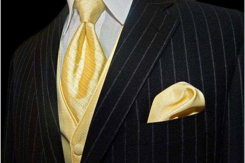 man wearing gold necktie on black stripe suit