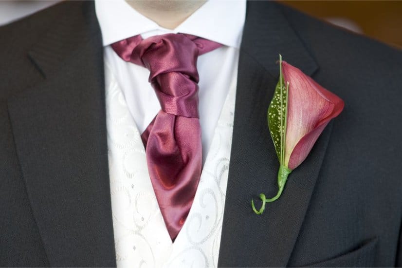 man with cravat and buttonhole flower