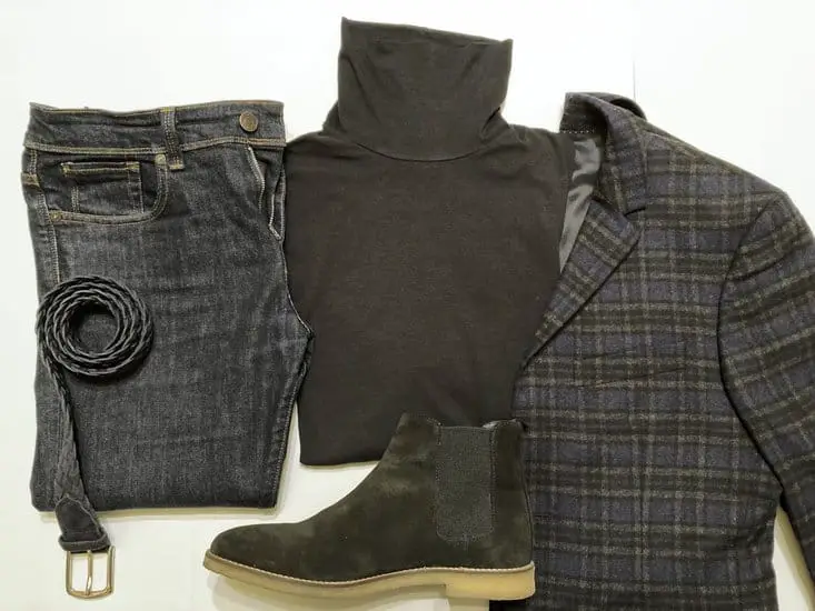 statement blazer on top of a black turtleneck with dark wash jeans, and black leather boots