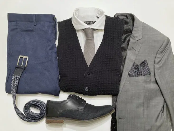 gray blazer with a white collared shirt, navy waistcoat and polished Oxford shoes