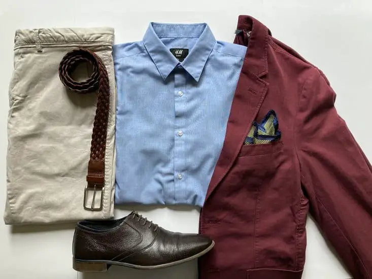 Maroon blazer with a light blue shirt, beige trousers and brown oxfords